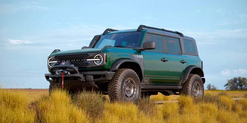 A green 2024 Ford Bronco sitting in a field, ready to blaze trails. 