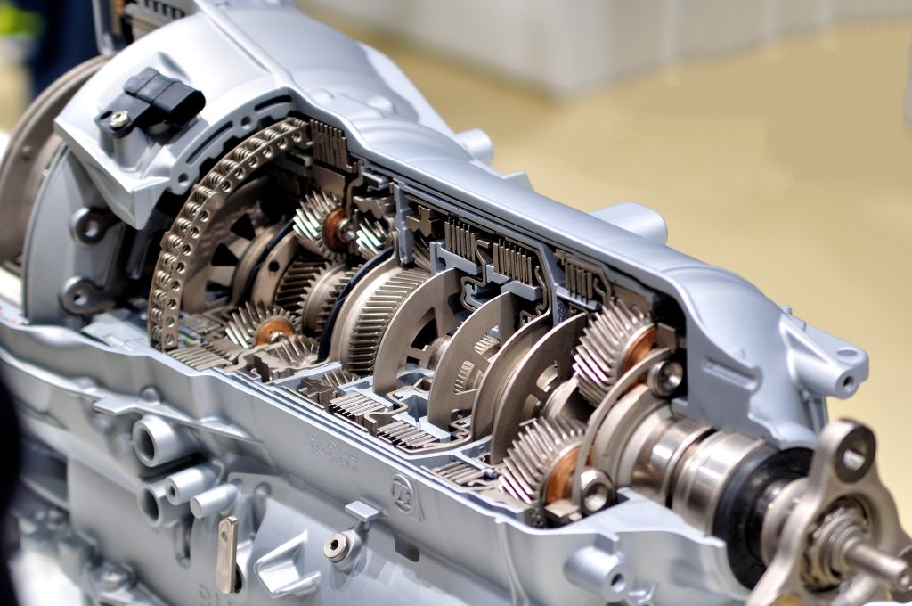 A cutaway photograph of a car transmission, showing all the working parts. 