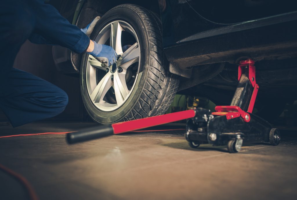 A service technician removing a tire.