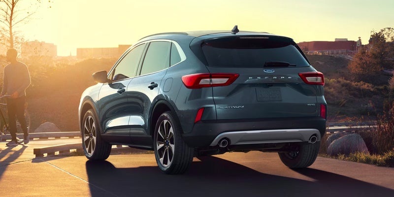 A 2024 Escape driving down the highway at dusk