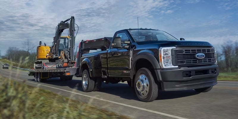 The Ford Super Duty towing a construction vehicle